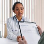 Doctor having a consultation with a patient over coronavirus test results in a medical office.