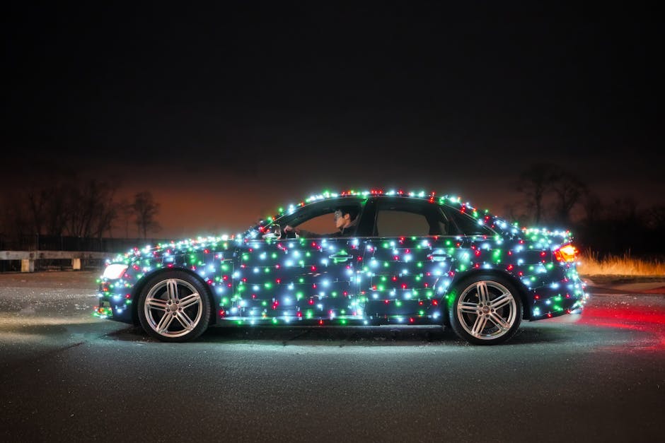 Car covered in bright Christmas lights parked outdoors at night. Festive holiday theme.