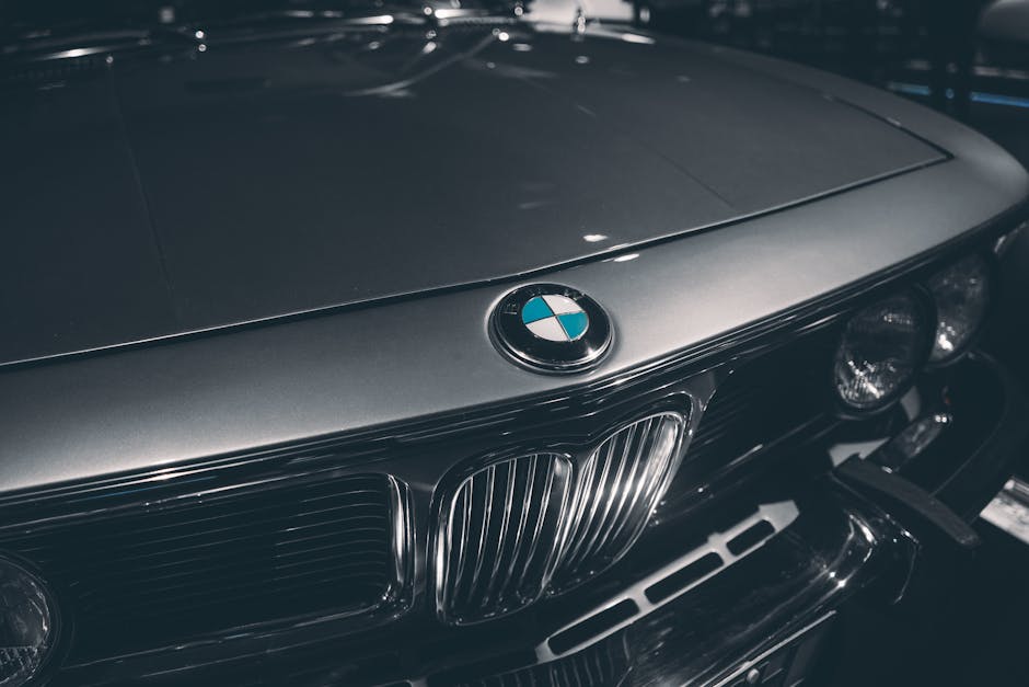 Close-up of classic BMW hood showcasing emblem and chrome details. Captured in Munich, Germany.