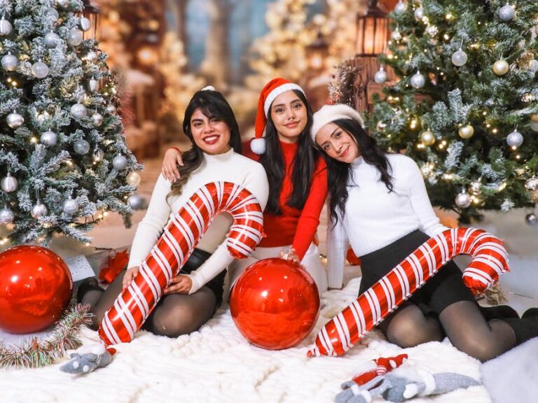 Three women celebrating Christmas with festive decorations and joyful smiles indoors.