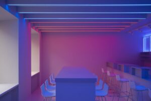 A sleek, minimalist room featuring vibrant LED lighting and contemporary seating arrangements.
