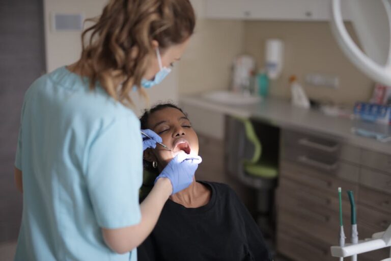 A female dentist performs a dental check-up on a patient in a clinic.