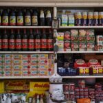 Explore a vintage grocery store shelf filled with bottles, canned goods, and more supplies.