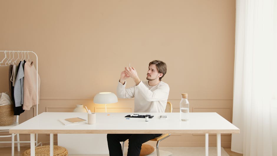 A man sits at a desk checking insulin levels, depicting a modern health lifestyle.