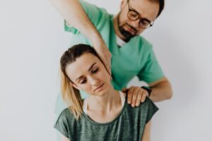 Professional chiropractor treating a woman's neck pain with therapeutic techniques.