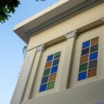 An elegant building facade with colorful stained glass windows, showcasing architectural beauty.