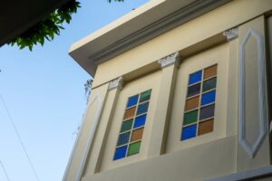 An elegant building facade with colorful stained glass windows, showcasing architectural beauty.