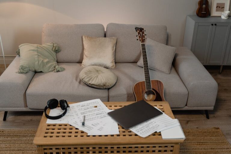 A comfortable home setting featuring a guitar on a sofa, ideal for music creation.